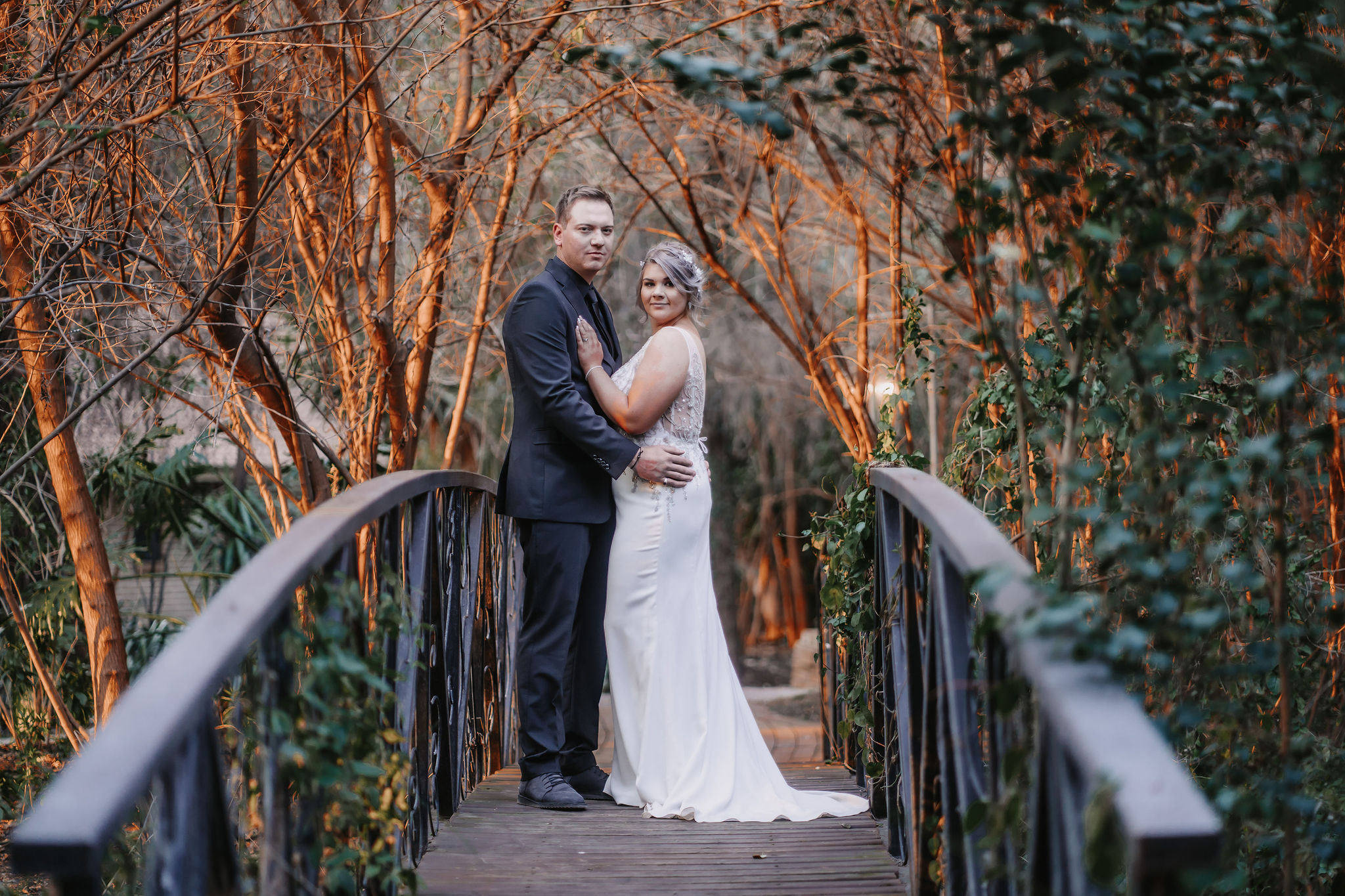 bell and blossom wedding couple on bridge